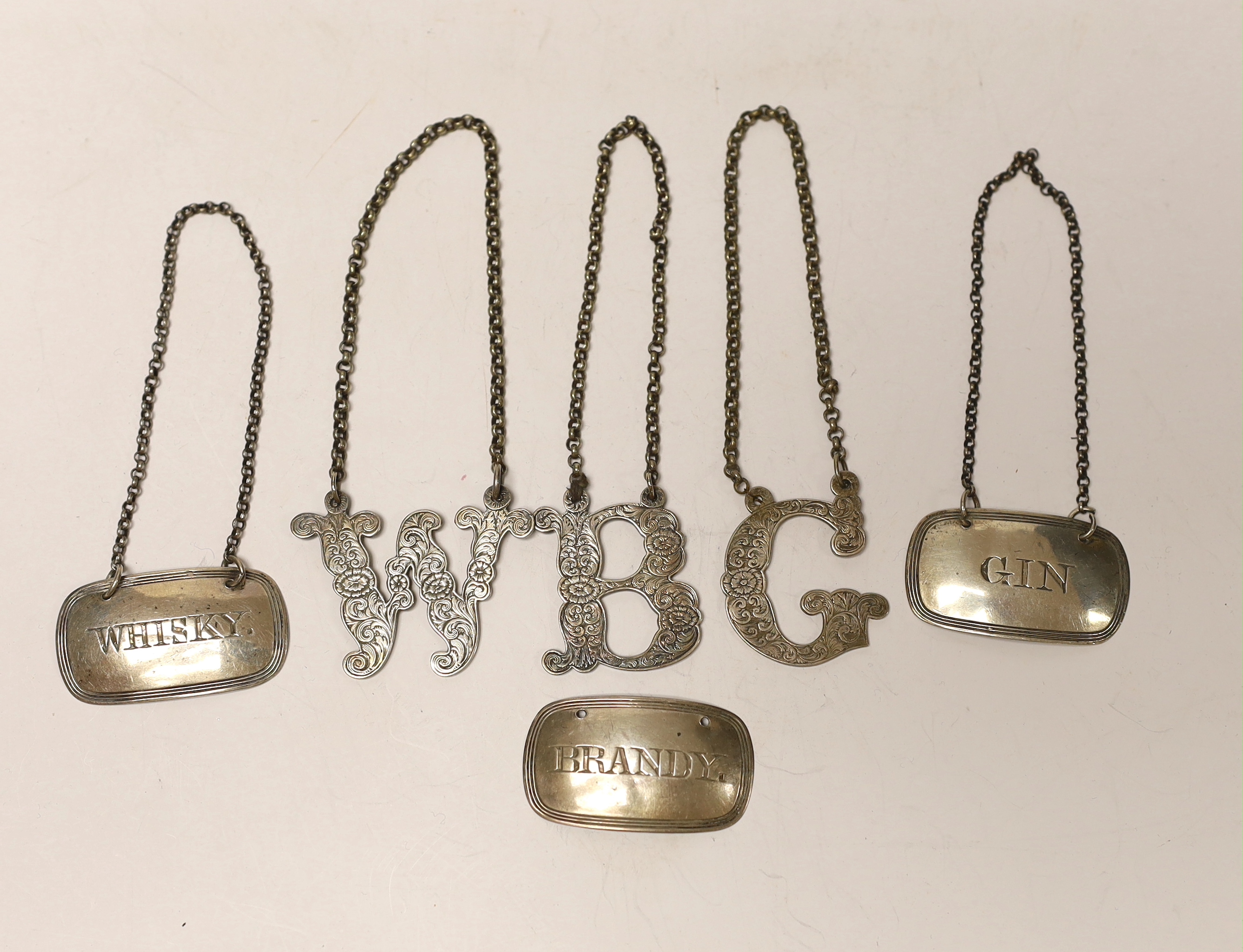 A set of three Victorian silver oval wine labels, Roberts & Belk, Sheffield, 1871, 43mm and three plated 'initial' wine labels.